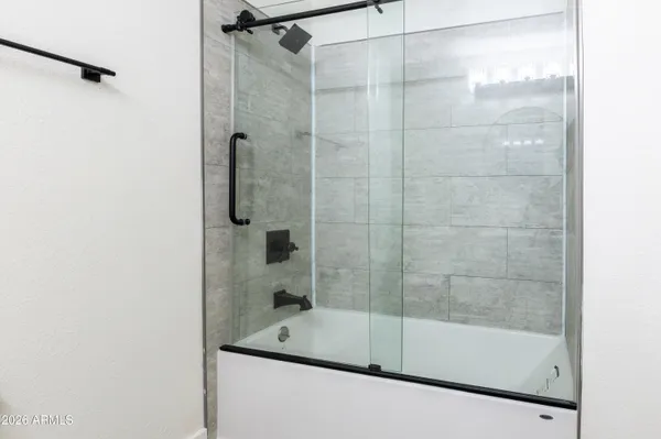 a bathroom with a bathtub and a shower