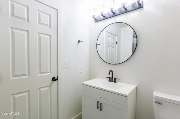 a bathroom with a sink a mirror and a toilet