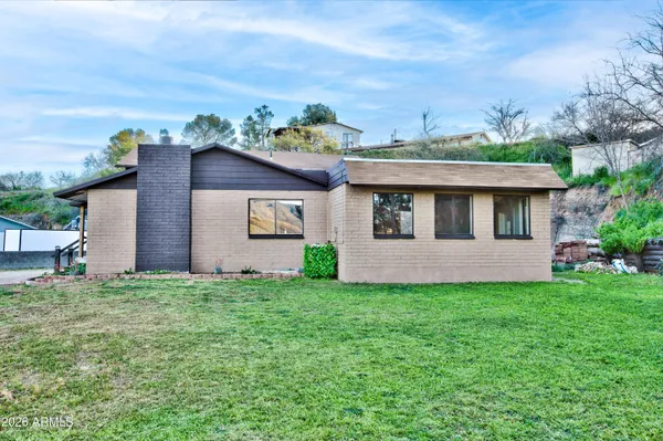 a view of a house with a yard and plants