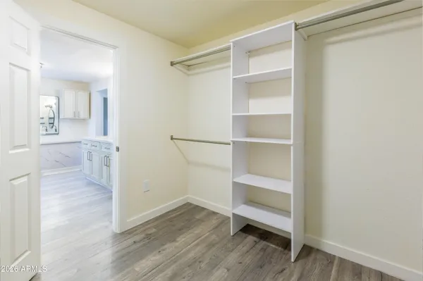 a view of an empty room with wooden floor