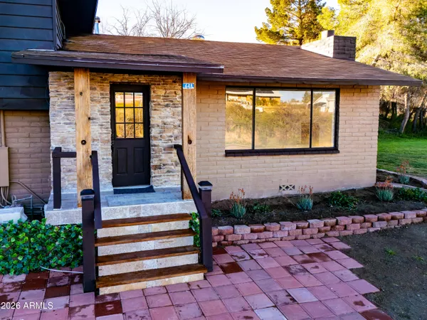 a front view of a house with a garden