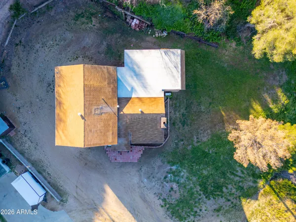 an aerial view of a house with garden space and a lake view