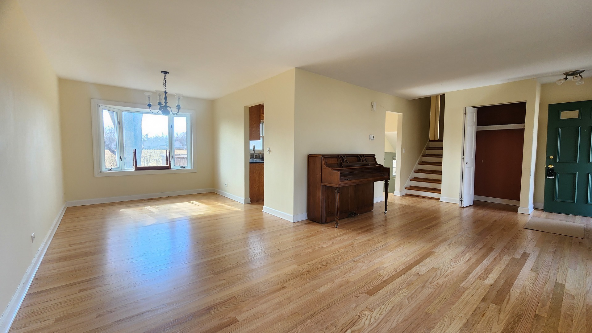 5 Castlegate Court Vernon Hills, IL 60061 - Photo 3 of 25 a view of an empty room with window and wooden floor