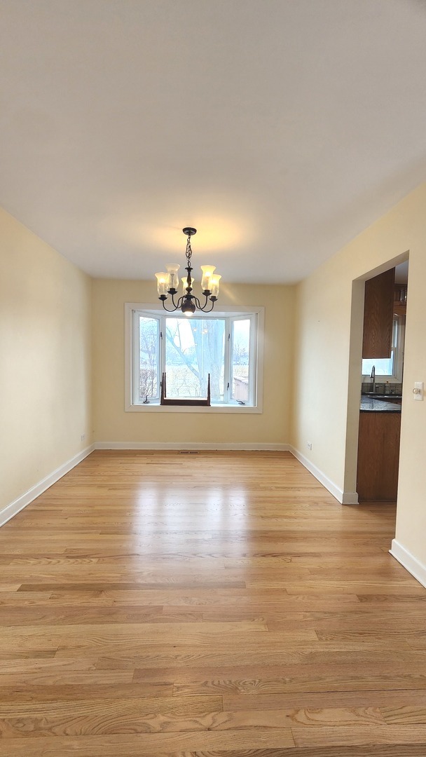 5 Castlegate Court Vernon Hills, IL 60061 - Photo 9 of 25 a view of an empty room with window and wooden floor