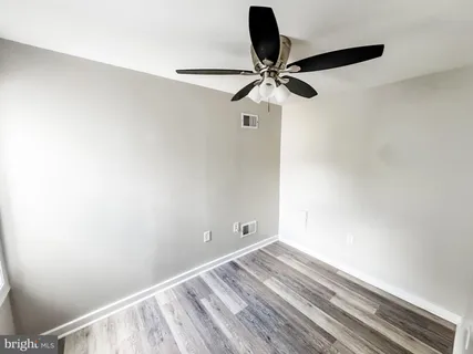 a view of room with a ceiling fan