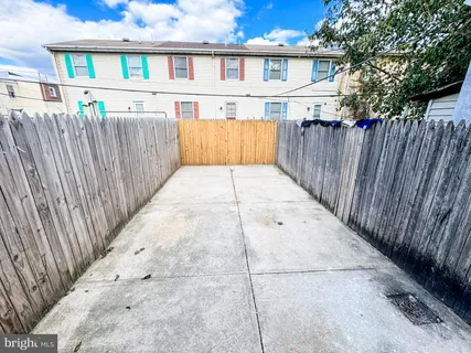 a front view of a house with wooden fence