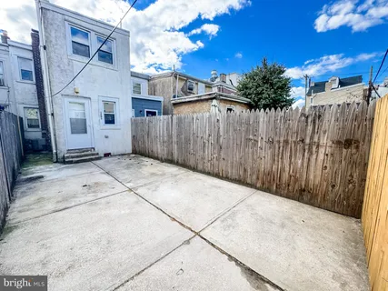 a view of a house with a wooden fence