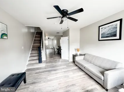 a living room with furniture and wooden floor