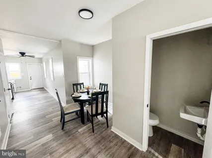 a view of a dining room with furniture and a chandelier