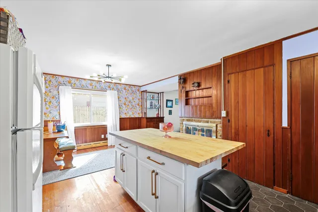 a kitchen with a stove a refrigerator and a dining table