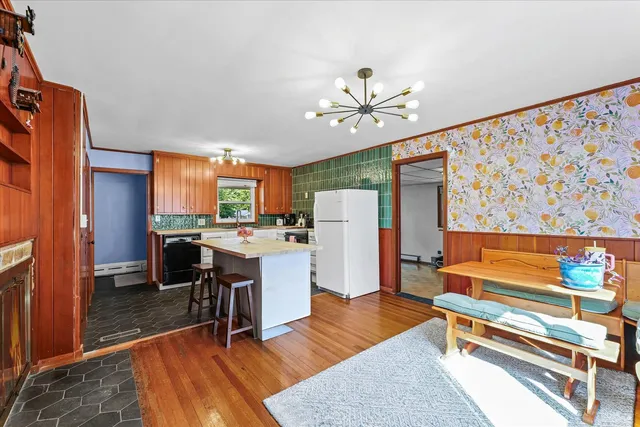 a living room with furniture a dining table and kitchen view