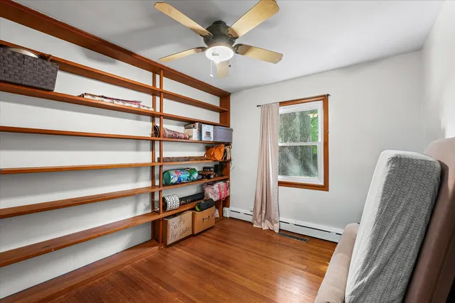 a view of room with window and wooden floor