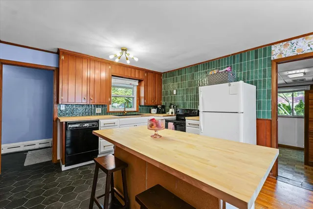 a kitchen with refrigerator and stove