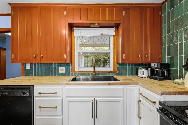 a kitchen with a sink cabinets and window