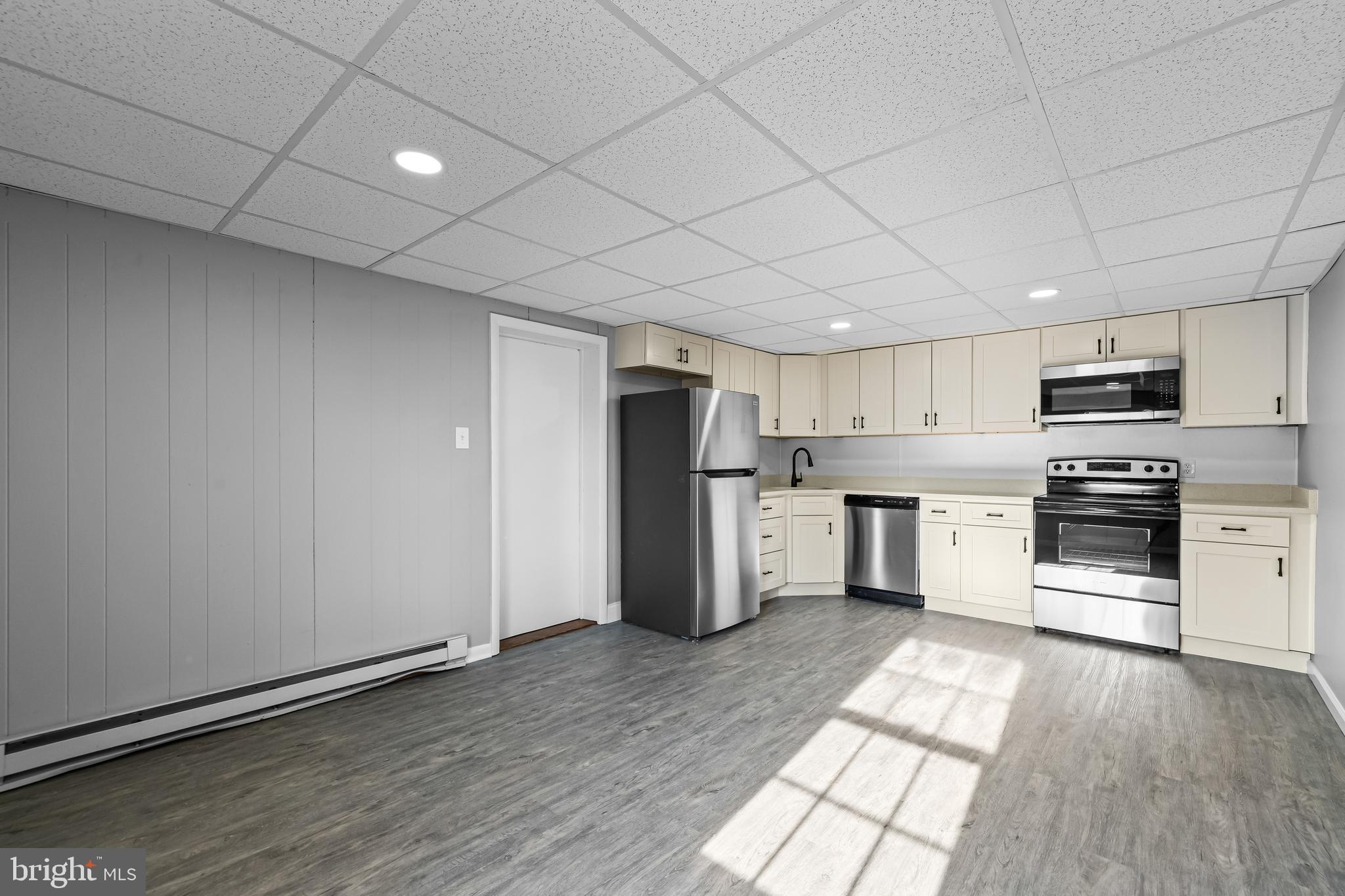 1480 Seven Valleys Road, Unit 2 York, PA 17408 - Photo 3 of 19 a kitchen with stainless steel appliances a refrigerator and a stove top oven