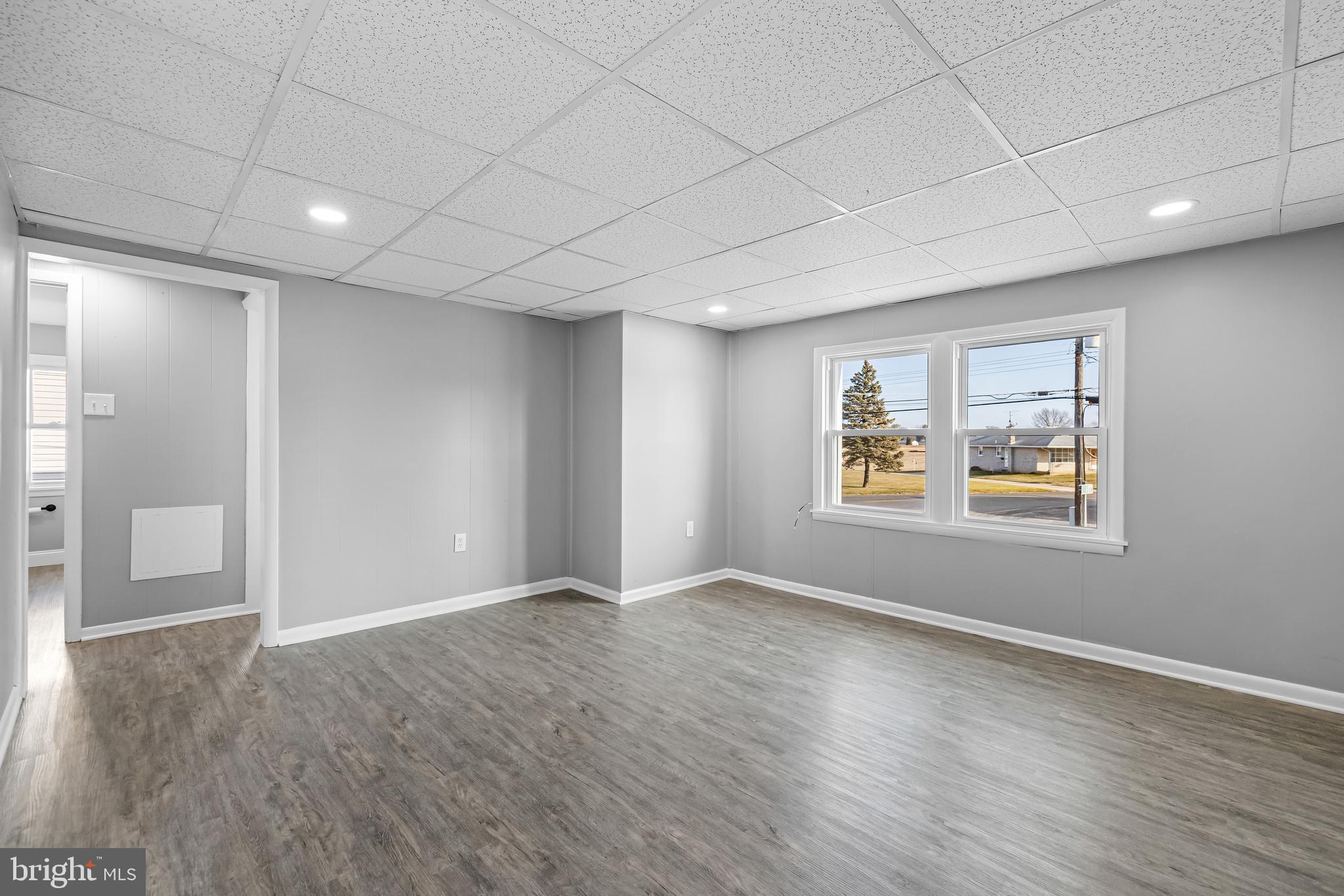 1480 Seven Valleys Road, Unit 2 York, PA 17408 - Photo 5 of 19 wooden floor in an empty room with a window