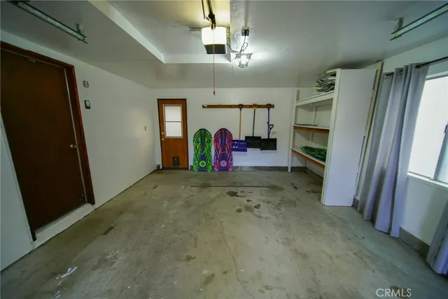 a view of a hallway with furniture and a refrigerator