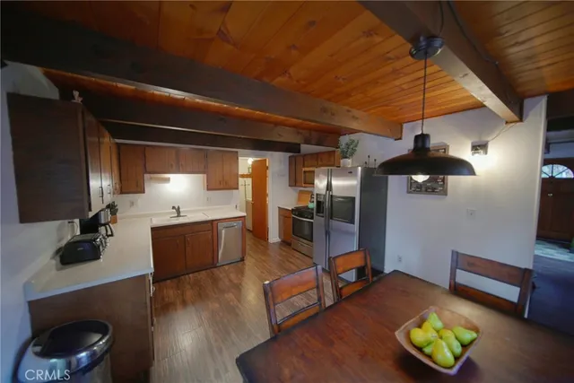 a kitchen with stainless steel appliances kitchen island granite countertop a sink dishwasher stove and cabinets