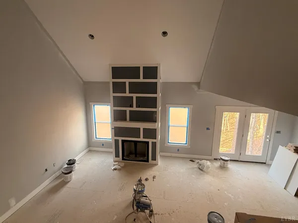 an empty room with a empty space and windows