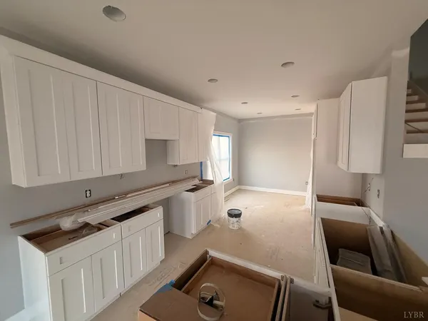 a large white room with a large window and white walls