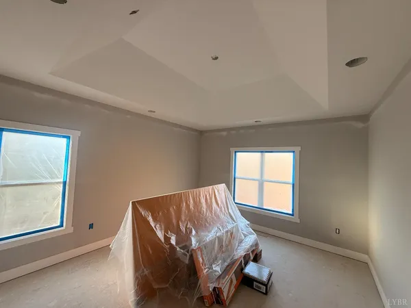 a living room with a bed and a refrigerator
