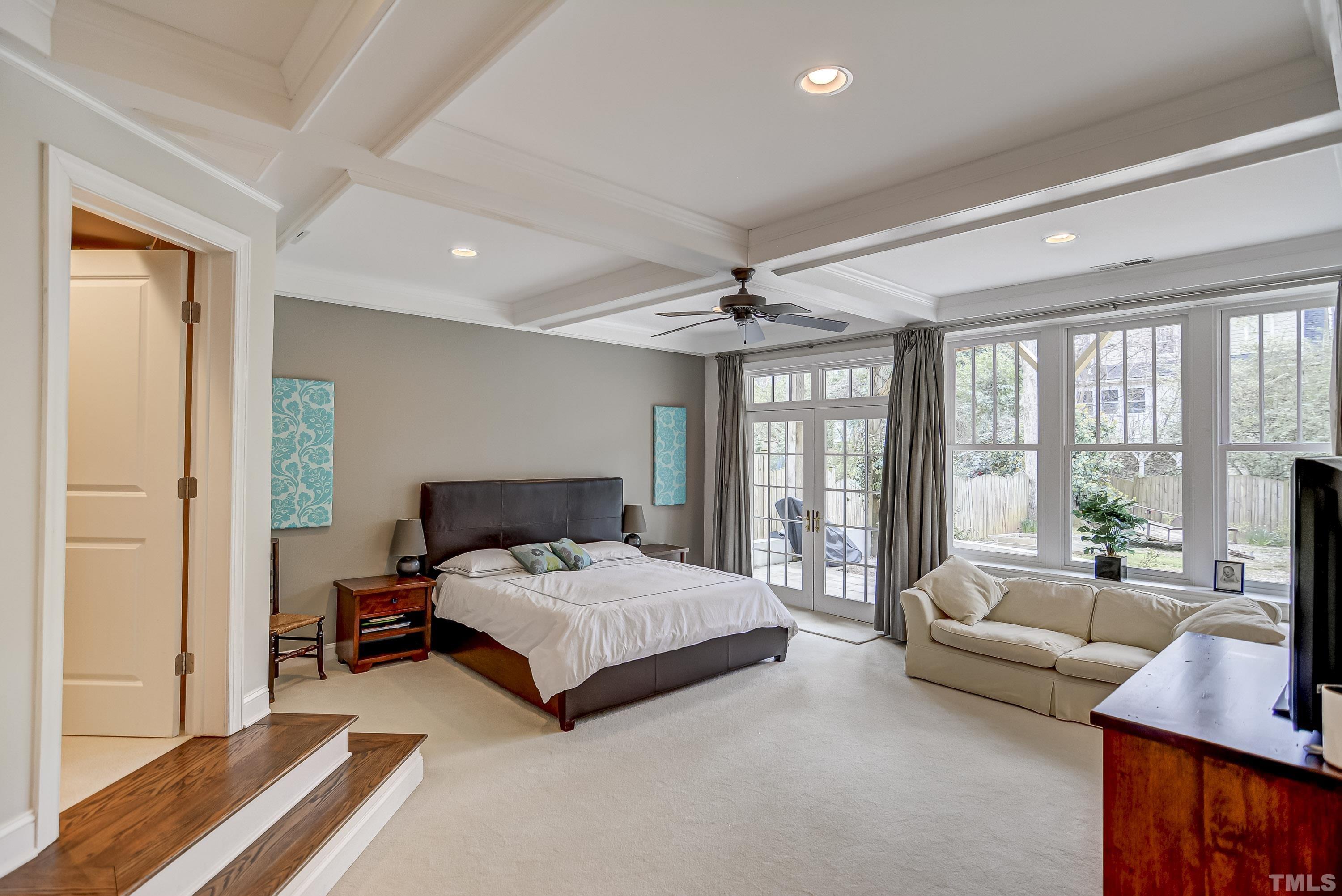 1924 Alexander Road Raleigh, NC 27608 - Photo 12 of 26 a bedroom with a bed couch and large windows