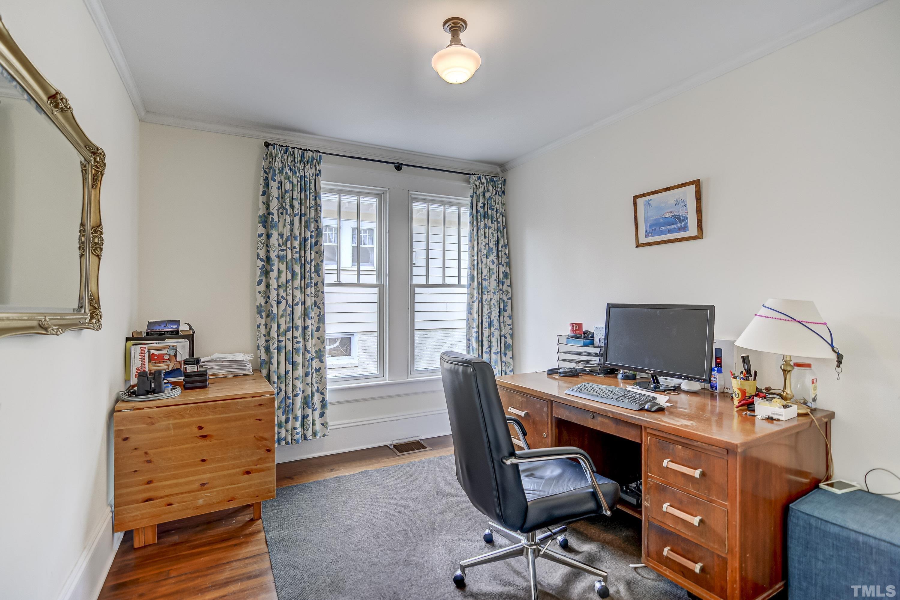 1924 Alexander Road Raleigh, NC 27608 - Photo 17 of 26 a view of a workspace with furniture and a window