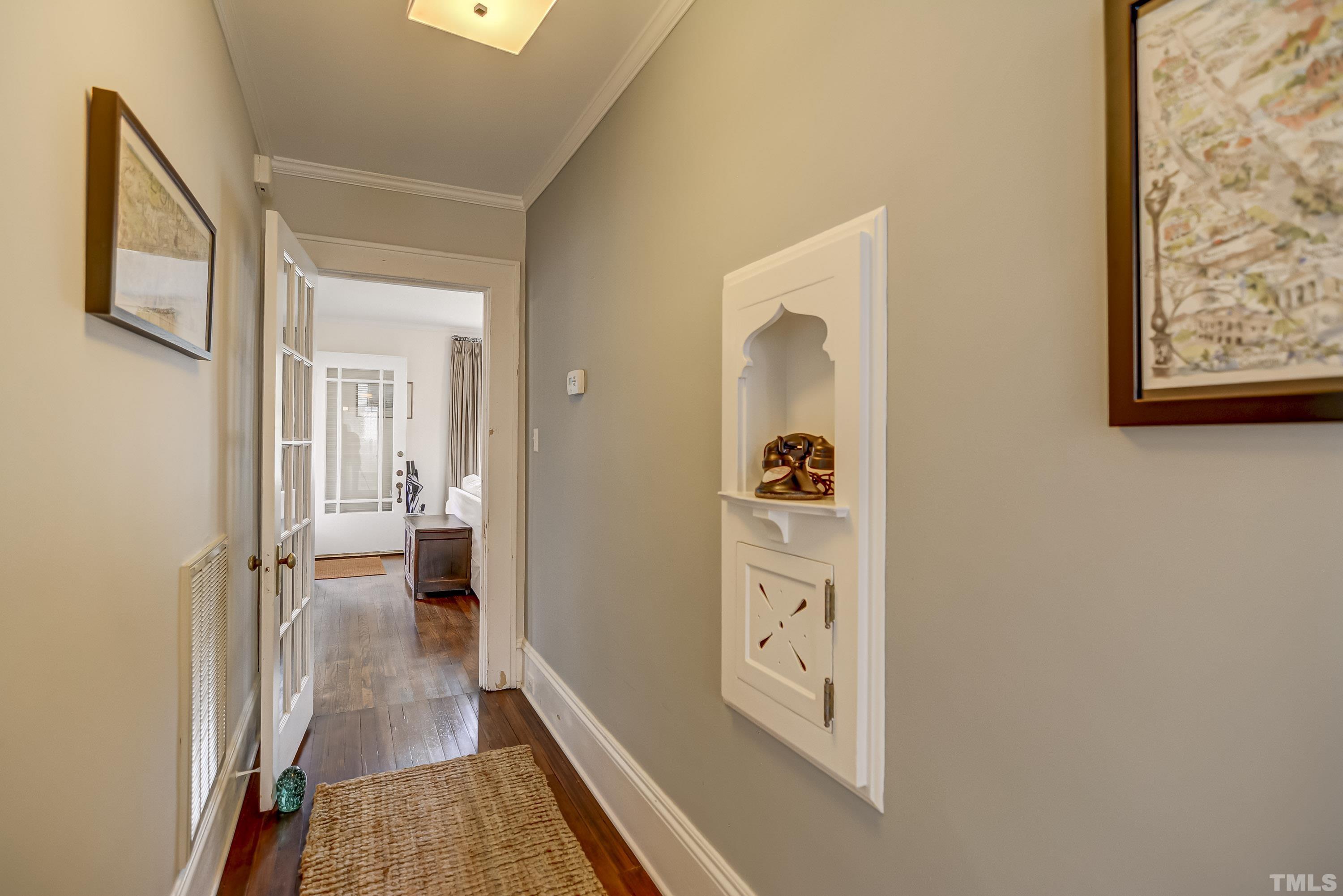 1924 Alexander Road Raleigh, NC 27608 - Photo 20 of 26 a view of a hallway and a livingroom with wooden floor