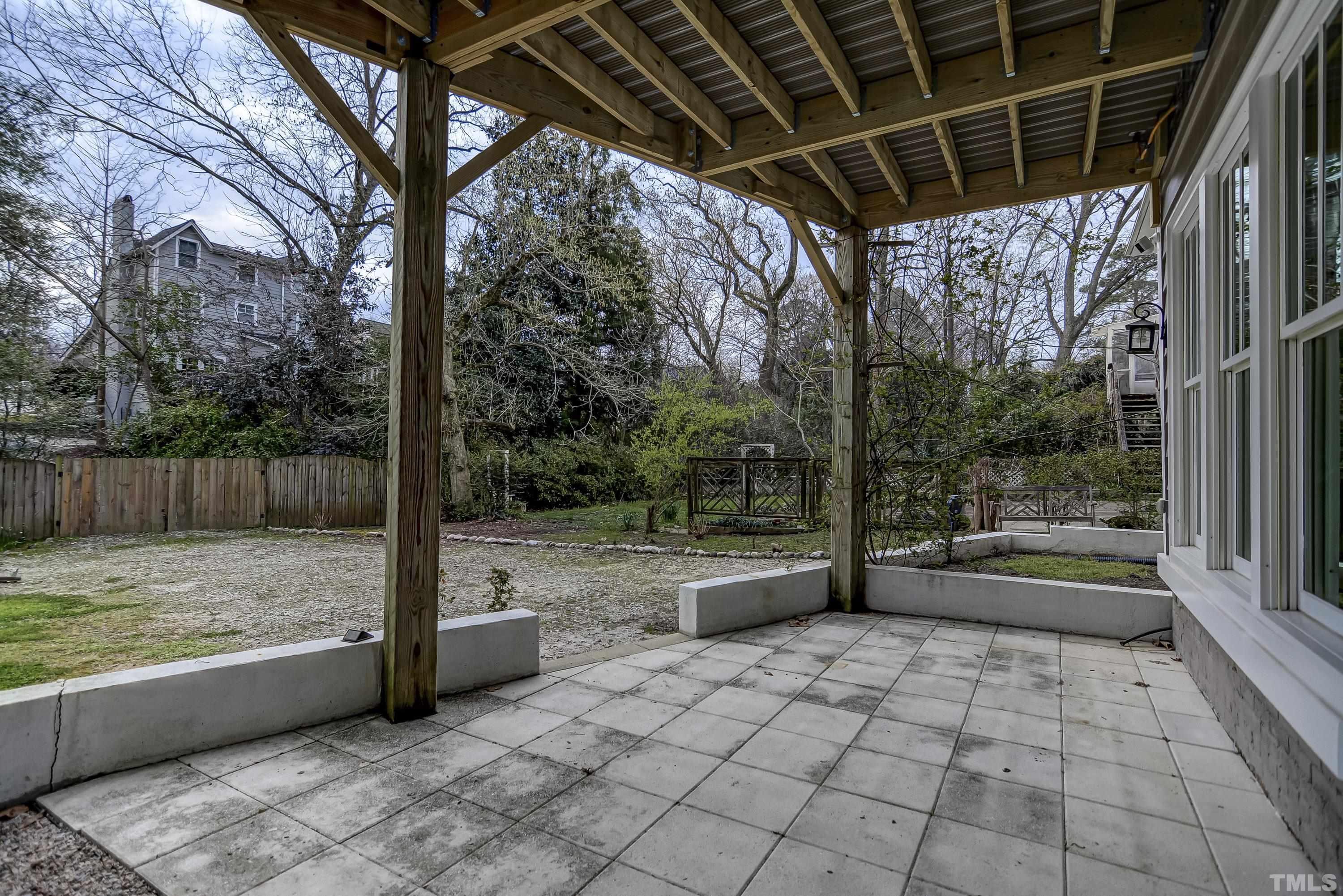 1924 Alexander Road Raleigh, NC 27608 - Photo 23 of 26 a view of a patio with a table and chairs