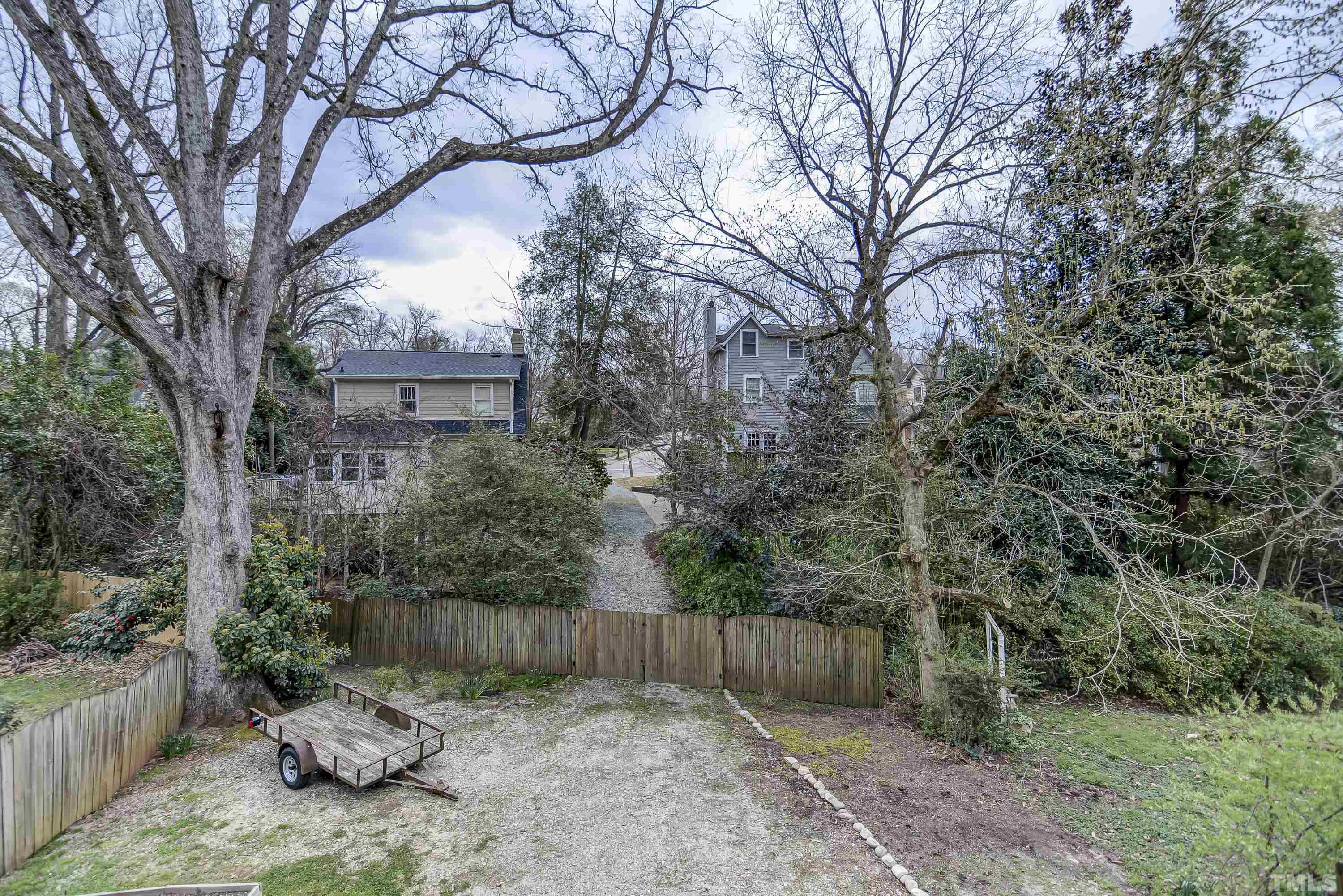 1924 Alexander Road Raleigh, NC 27608 - Photo 26 of 26 a backyard of a house with lots of green space and wooden fence
