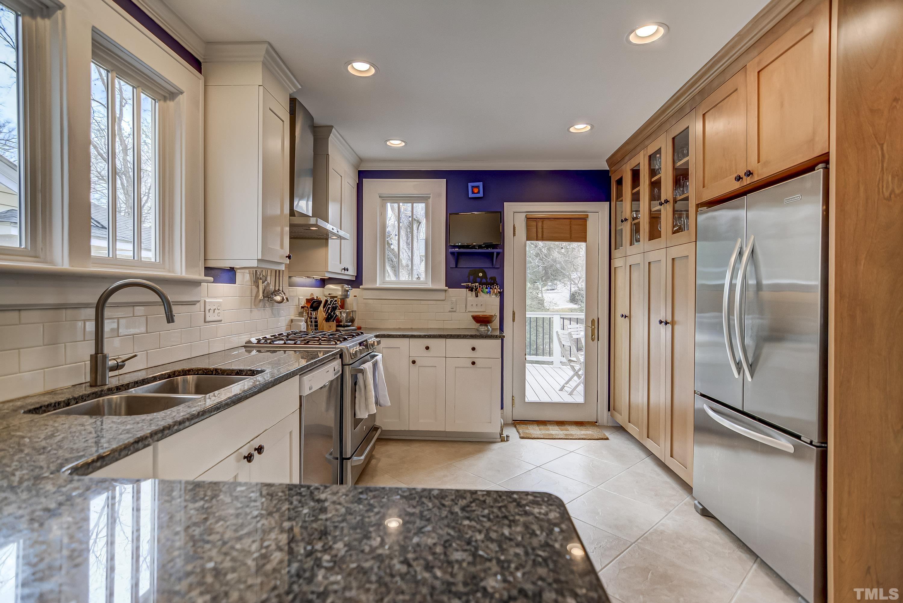 1924 Alexander Road Raleigh, NC 27608 - Photo 6 of 26 a kitchen with stainless steel appliances granite countertop a refrigerator a sink a stove and white cabinets