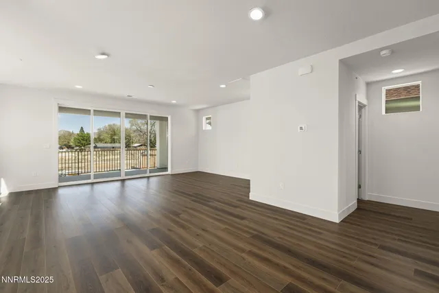 a view of wooden floor and windows in a room