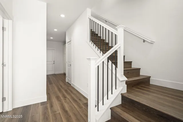 a view of entryway and hall with wooden floor