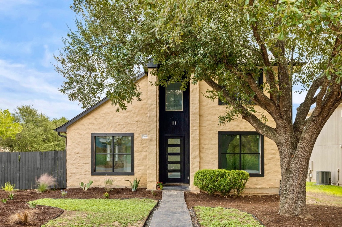 front view of a house with a tree in front of it