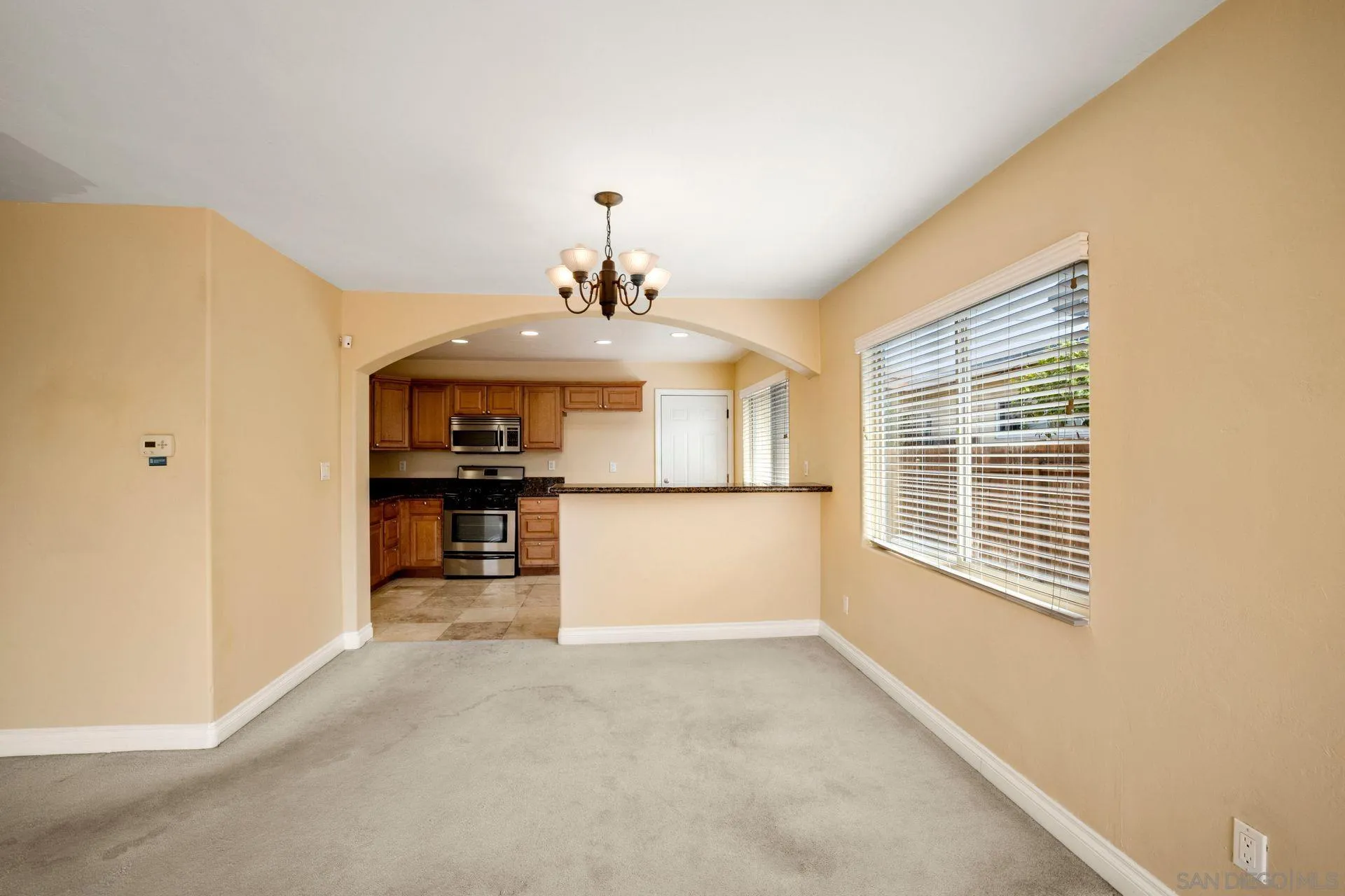 2742 Murray Ridge Road San Diego, CA 92123 - Photo 14 of 34 a view of a kitchen with a sink cabinets and a window