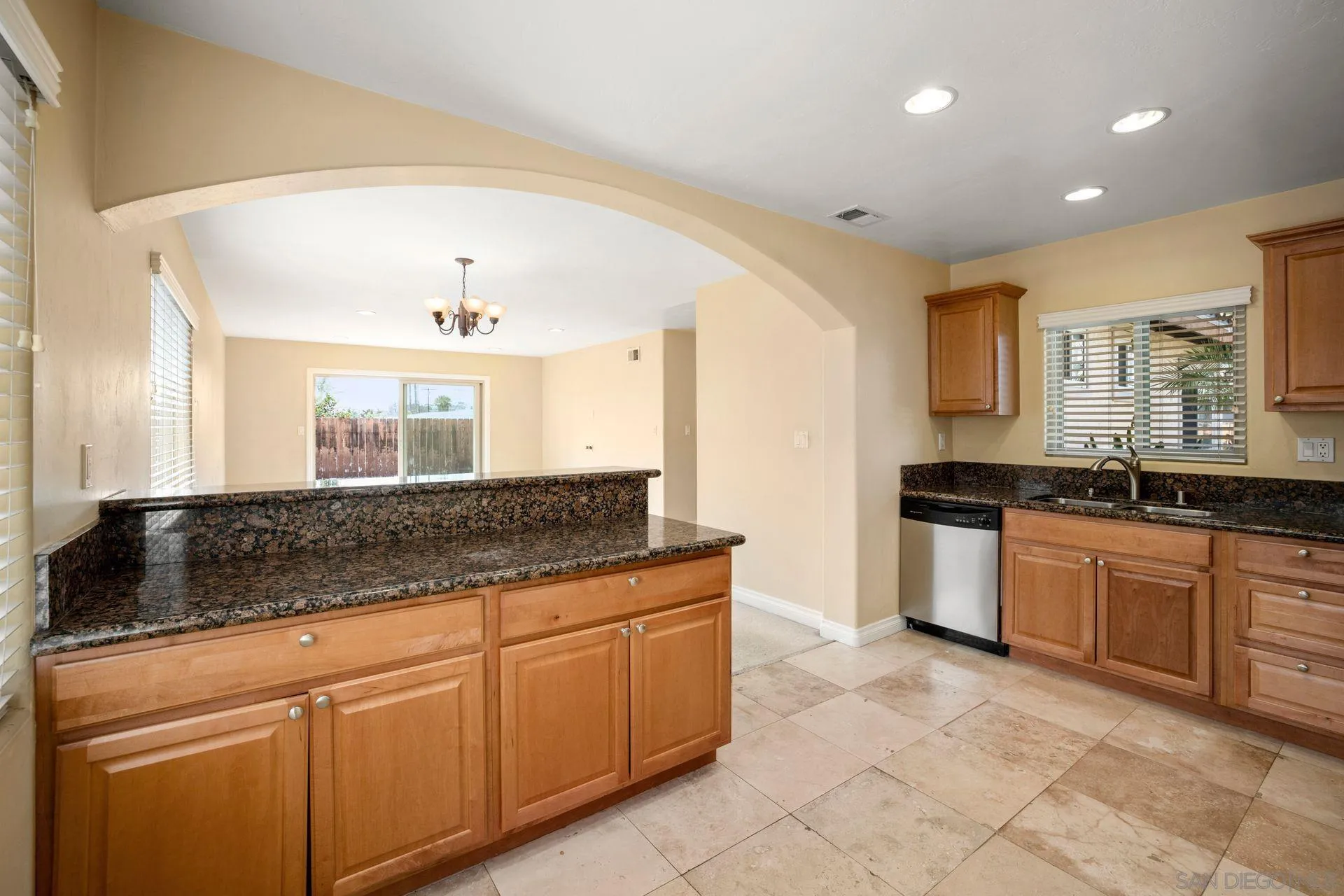 2742 Murray Ridge Road San Diego, CA 92123 - Photo 19 of 34 a kitchen with granite countertop a sink and white cabinets