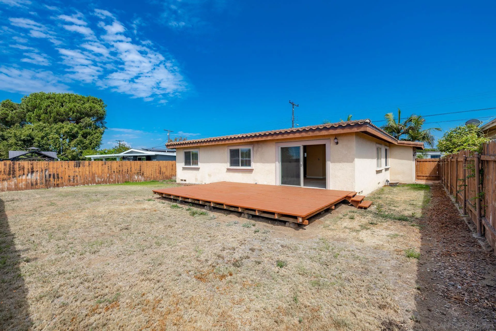 2742 Murray Ridge Road San Diego, CA 92123 - Photo 29 of 34 a view of a house with backyard and trees