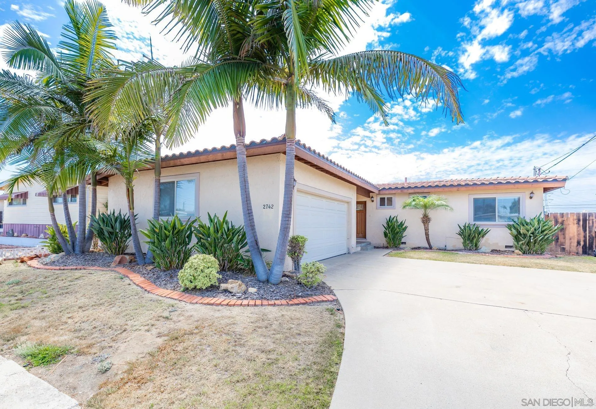2742 Murray Ridge Road San Diego, CA 92123 - Photo 3 of 34 a front view of house with a garden