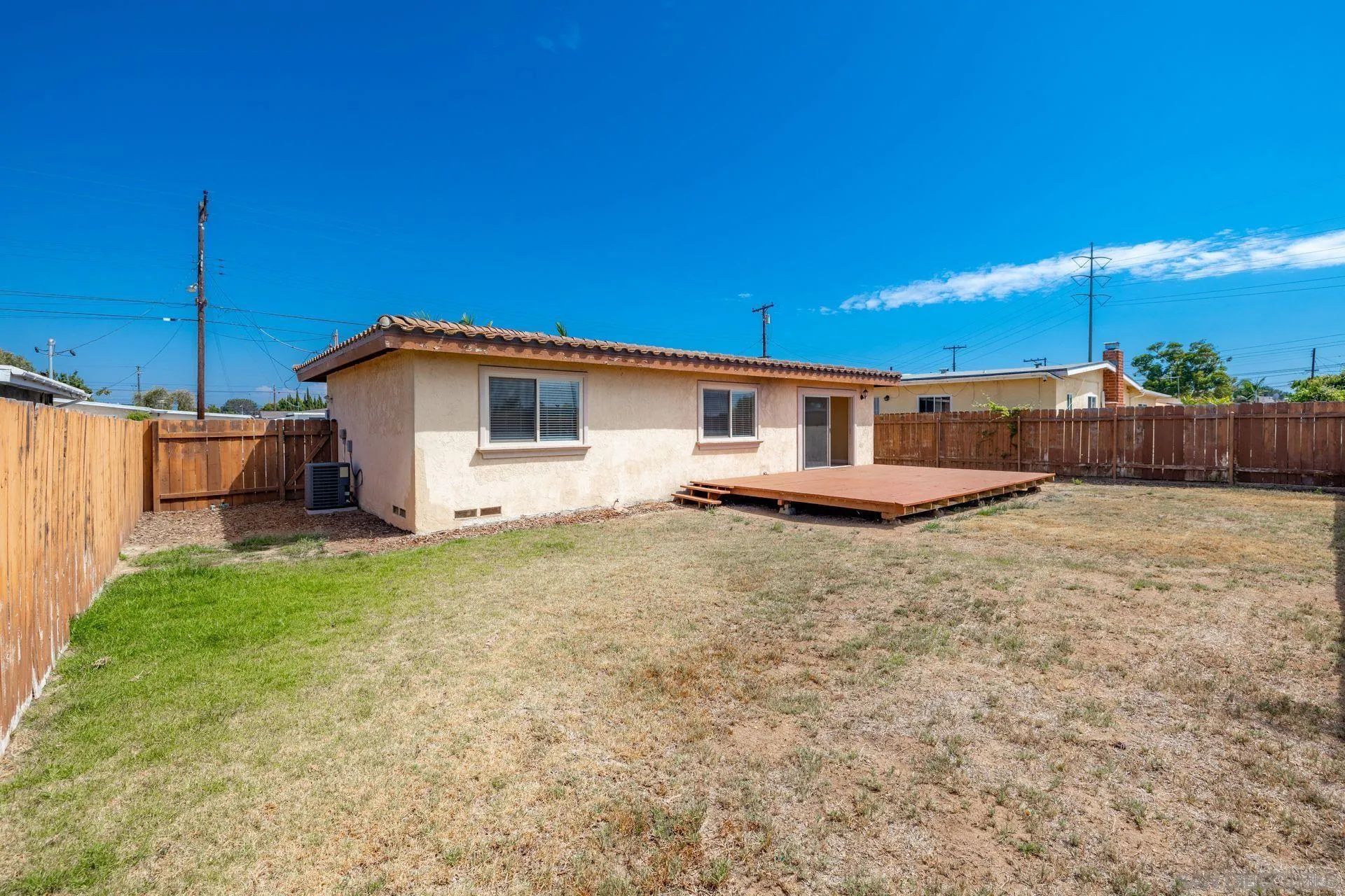 2742 Murray Ridge Road San Diego, CA 92123 - Photo 32 of 34 a backyard of a house with table and chairs