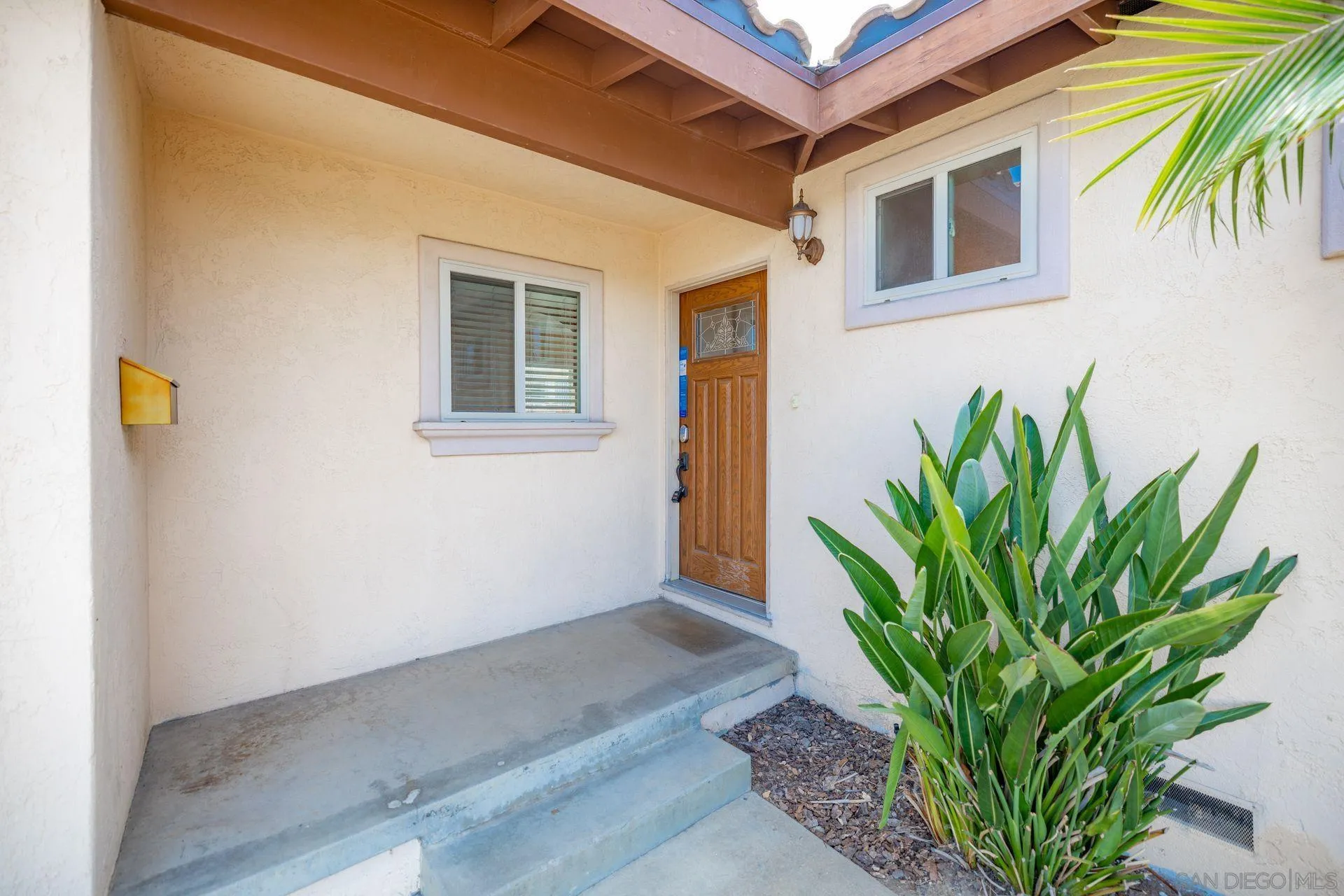 2742 Murray Ridge Road San Diego, CA 92123 - Photo 7 of 34 a plant is in front of a house
