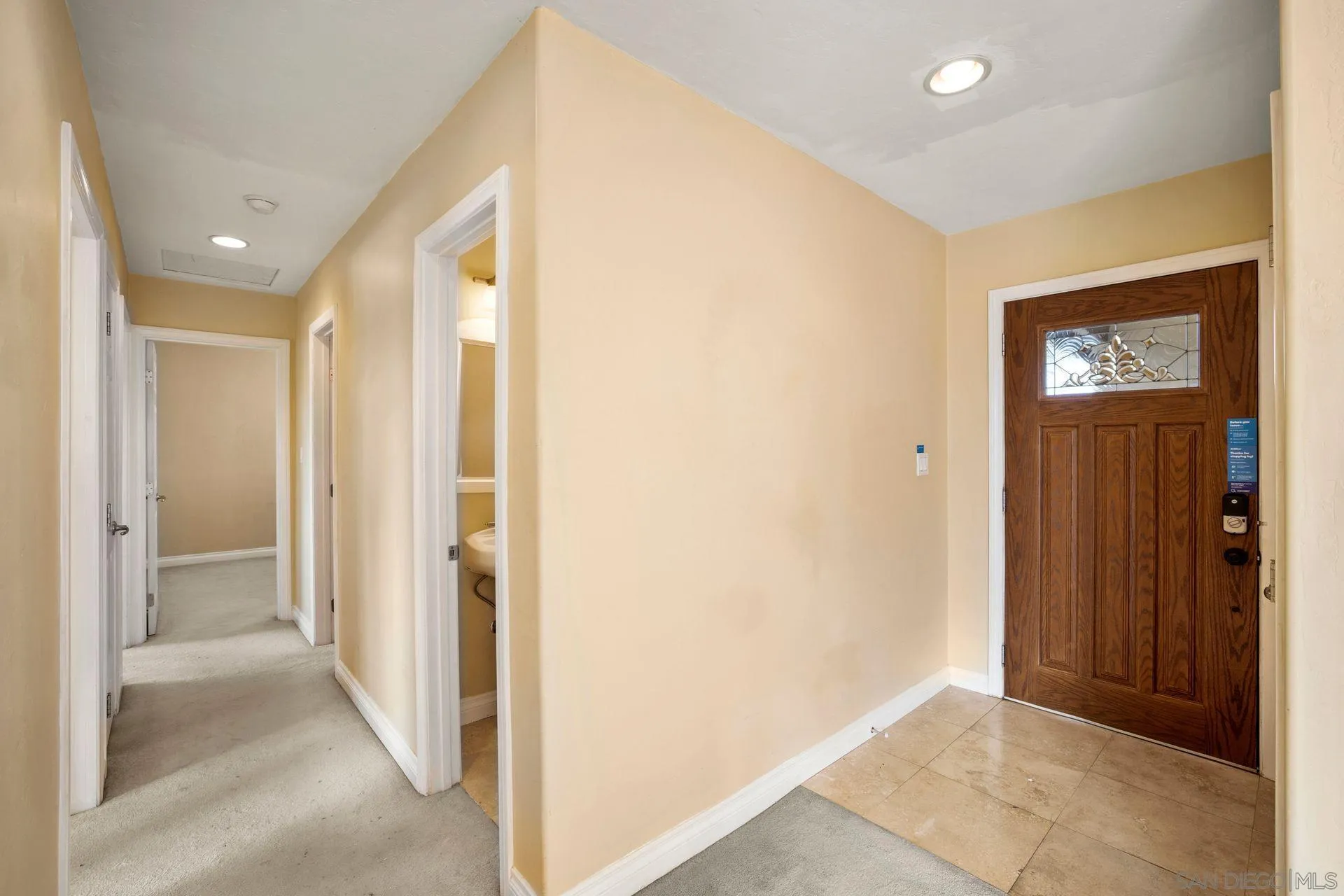2742 Murray Ridge Road San Diego, CA 92123 - Photo 8 of 34 a view of a hallway with wooden floor and a bathroom