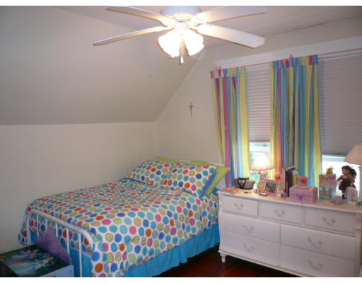 34 Edgemere Road Boston, MA 02132 - Photo 11 of 16 a bedroom with a bed and a chandelier