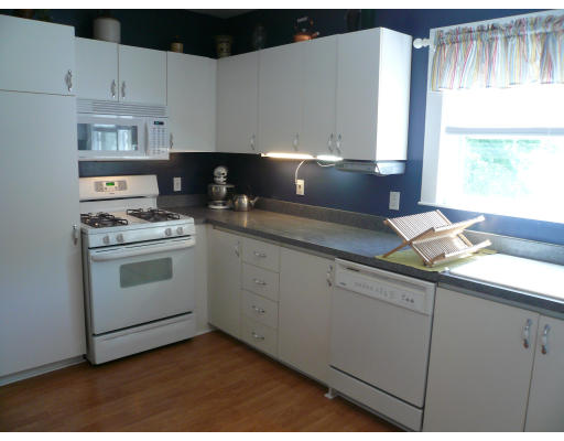 34 Edgemere Road Boston, MA 02132 - Photo 8 of 16 a kitchen with granite countertop white cabinets and white appliances