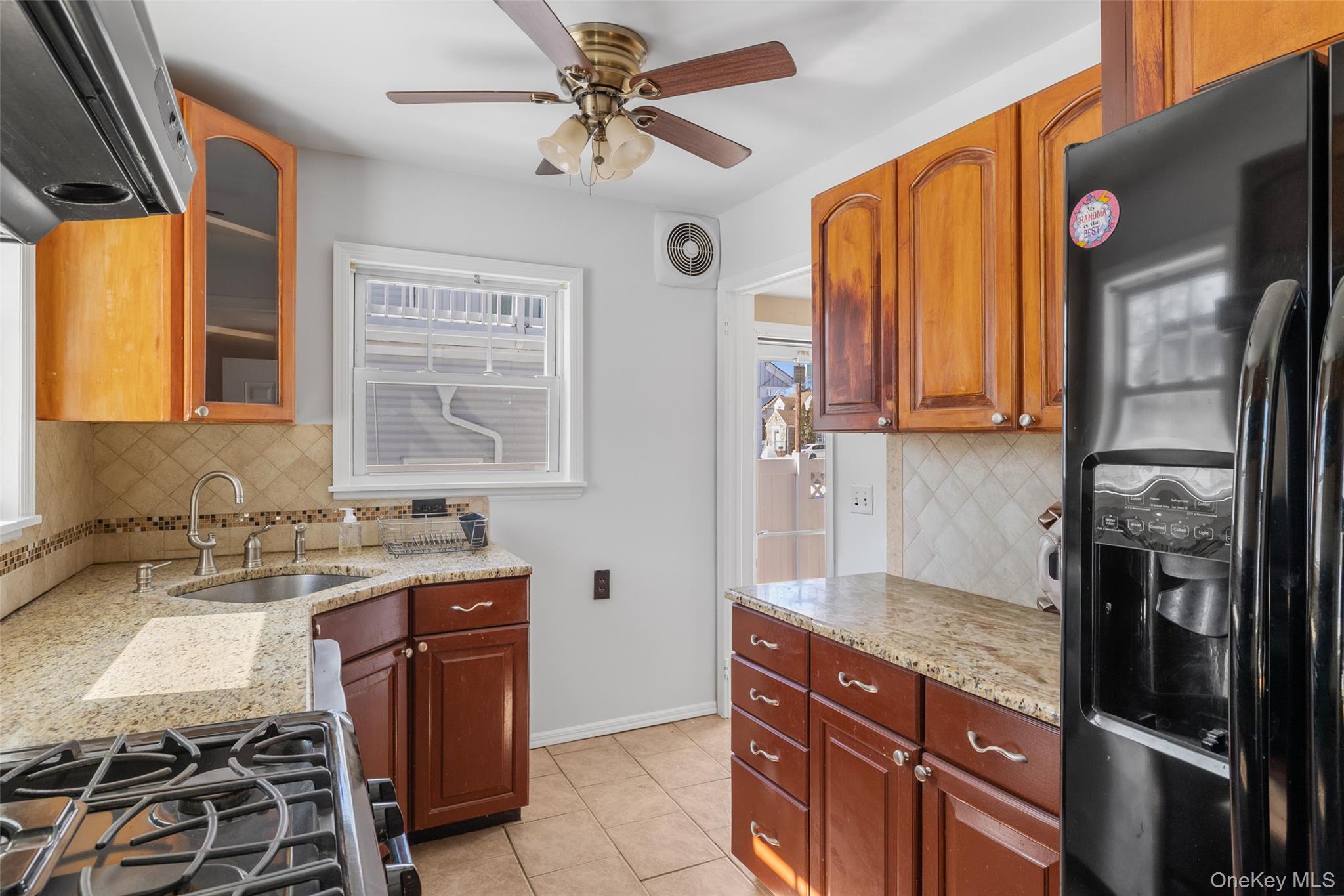 682 Rose Boulevard Baldwin, NY 11510 - Photo 11 of 22 a kitchen with stainless steel appliances granite countertop a refrigerator and a sink
