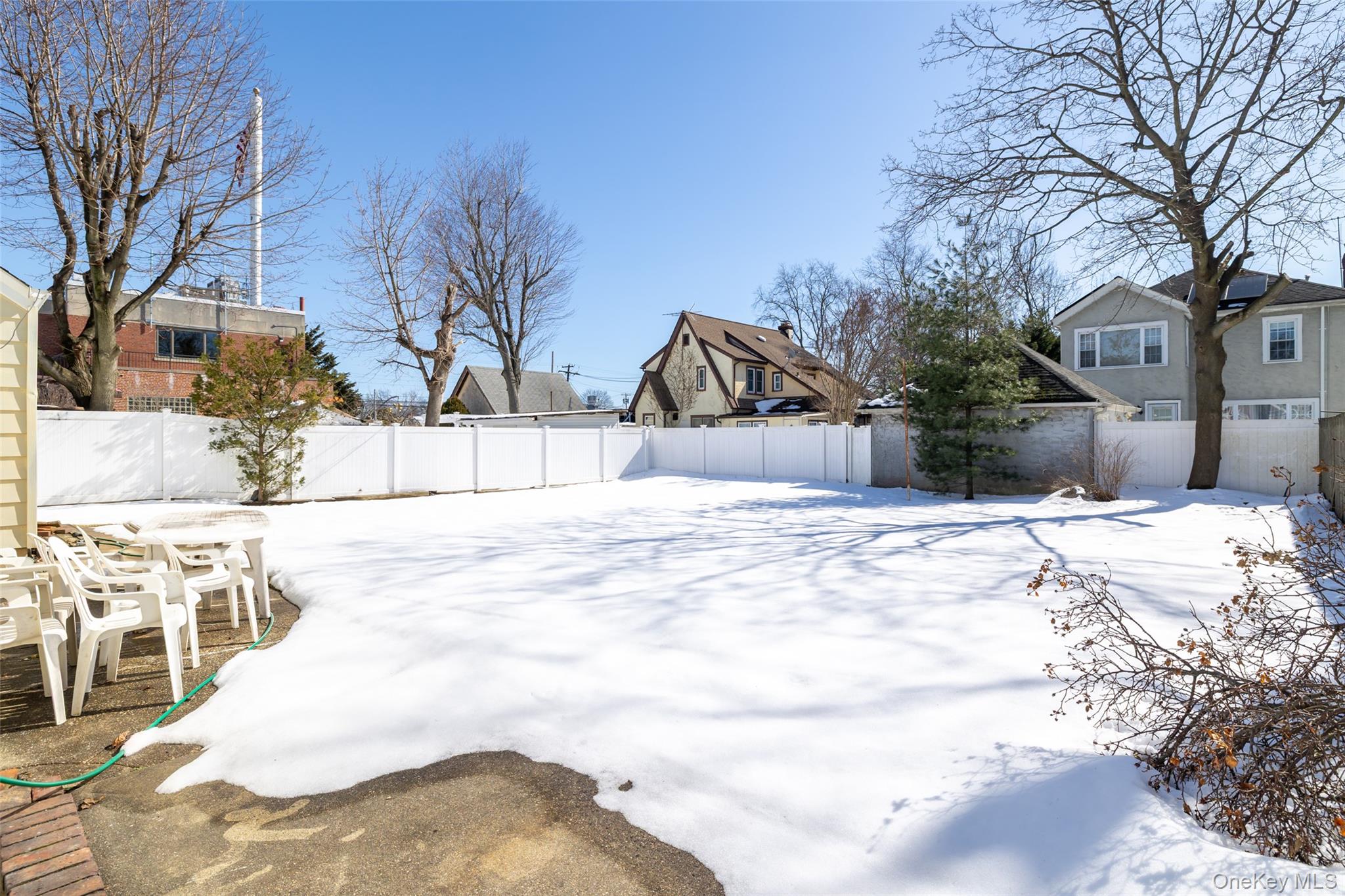 682 Rose Boulevard Baldwin, NY 11510 - Photo 19 of 22 a view of a yard covered in snow