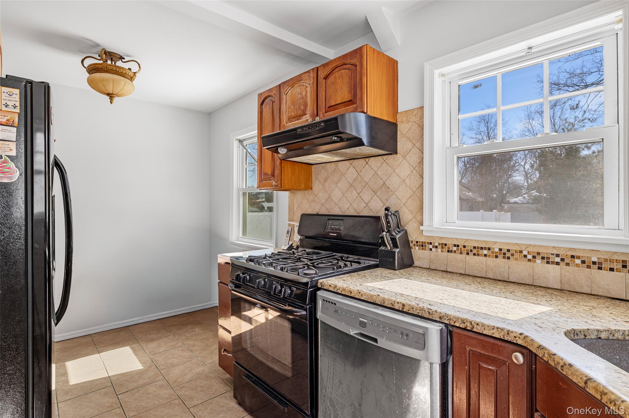 682 Rose Boulevard Baldwin, NY 11510 - Photo 3 of 22 a kitchen with stainless steel appliances granite countertop a stove a refrigerator and a cabinets