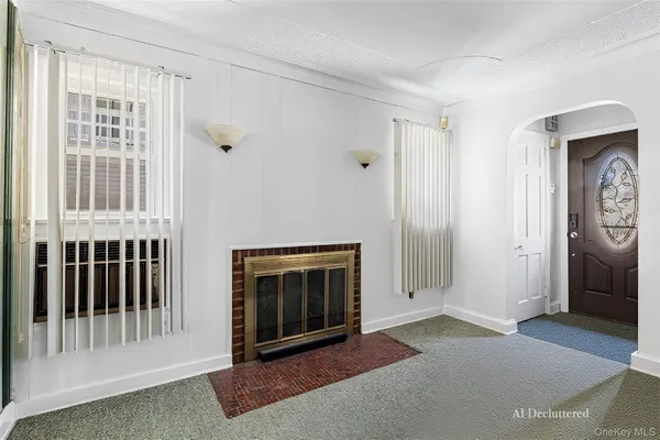 a view of a livingroom with an empty space and a fireplace