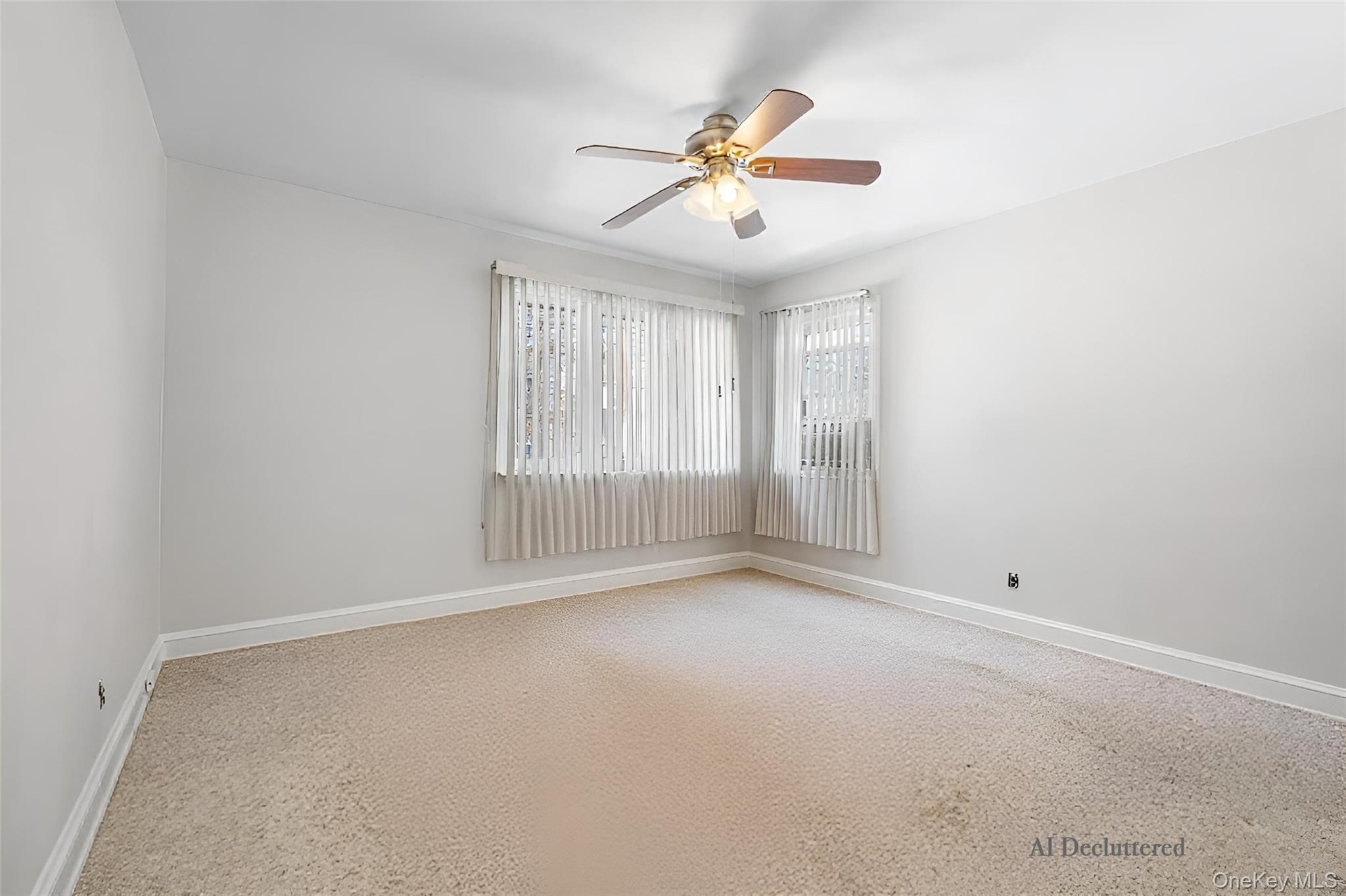 682 Rose Boulevard Baldwin, NY 11510 - Photo 9 of 22 an empty room with ceiling fan and windows