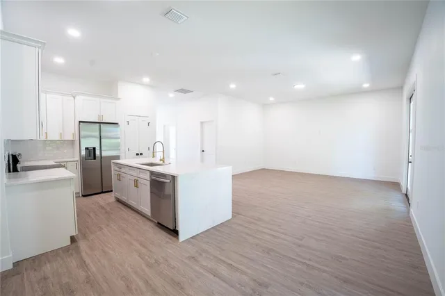 a kitchen with white cabinets and white appliances