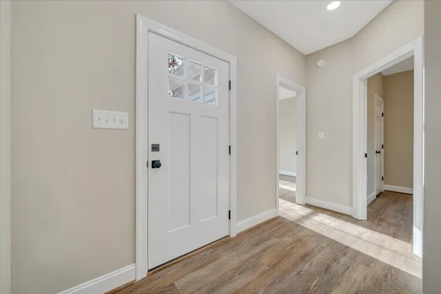 wooden floor in an empty room with a window
